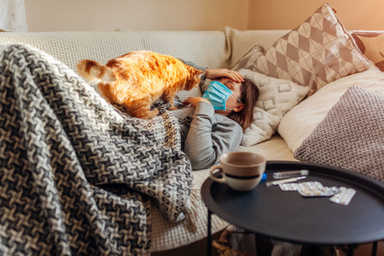 cat woman sick mask couch