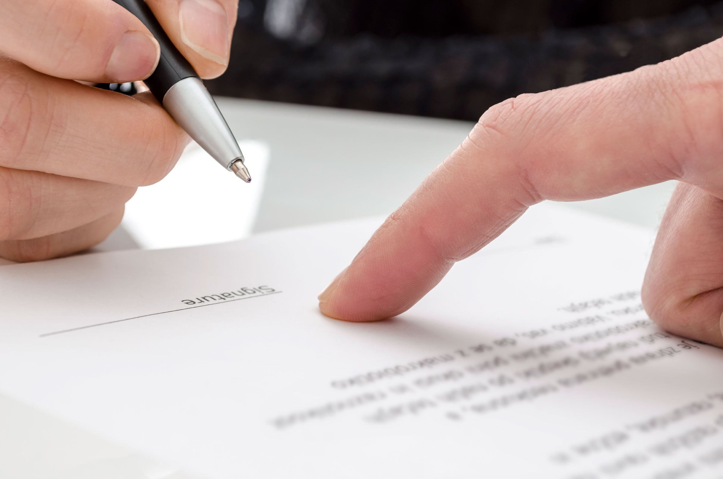 contract closeup pointing to where to sign