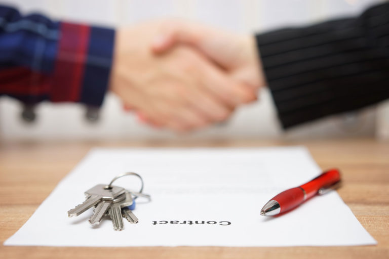 shaking hands over contract negotiation