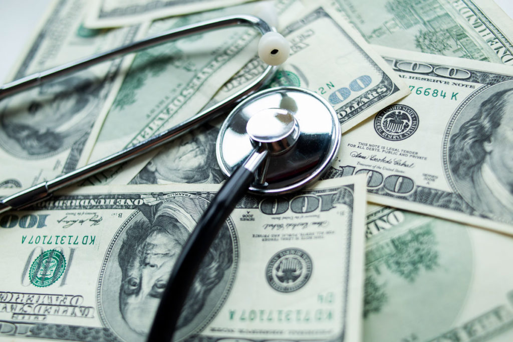 stethoscope money, representing veterinary fees. 