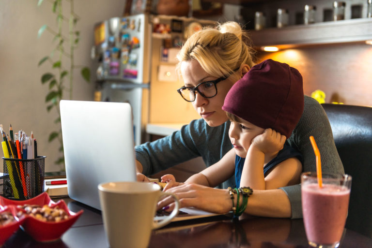 vet woman computer home working toddler helping
