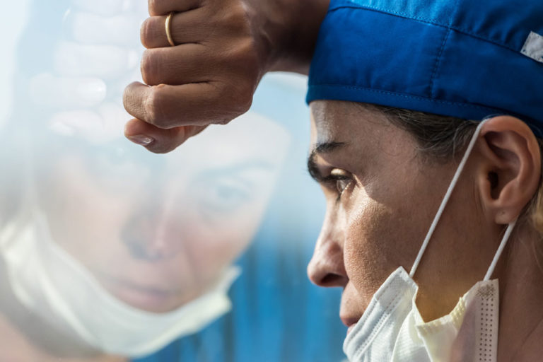 vet woman stress depressed looking out window