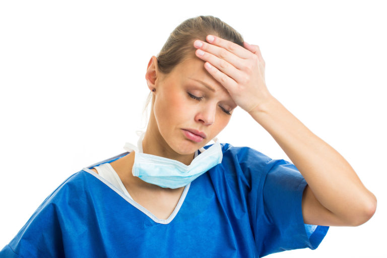 vet-woman-scrubs-hand-on-forehead-iStock-499663639-2400