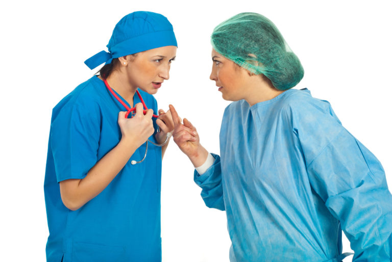 women veterinarians scrubs arguing