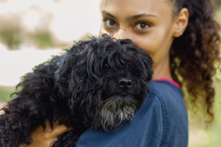 young woman of color with dog