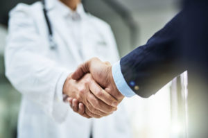 shaking hands vet businessman closeup