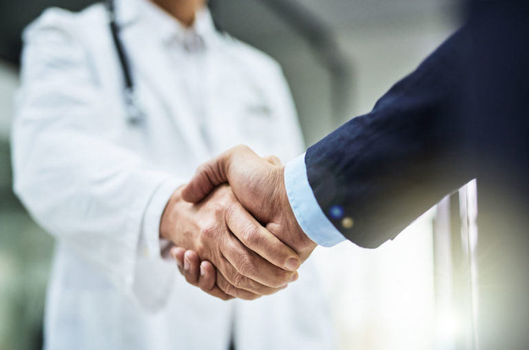 shaking hands vet businessman closeup