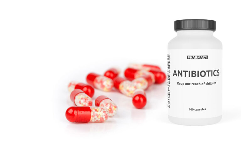 antibiotic bottle and pills