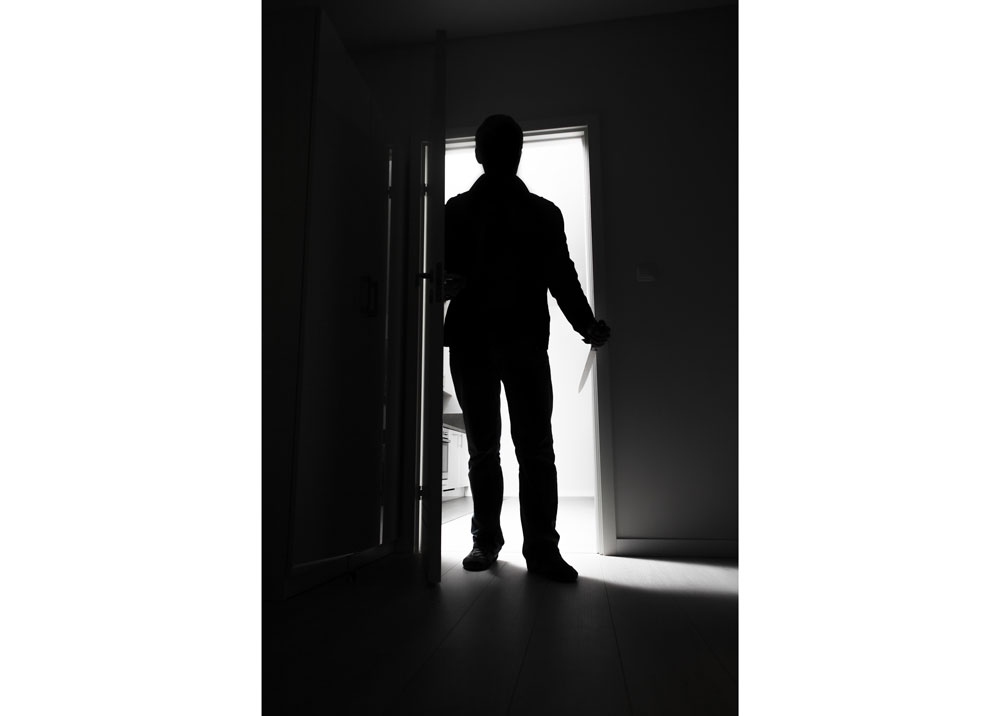 man entering dark room