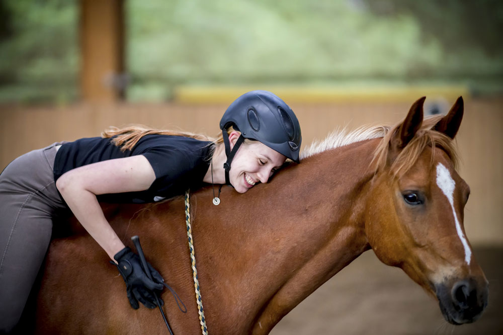woman bareback bridleless happy horse