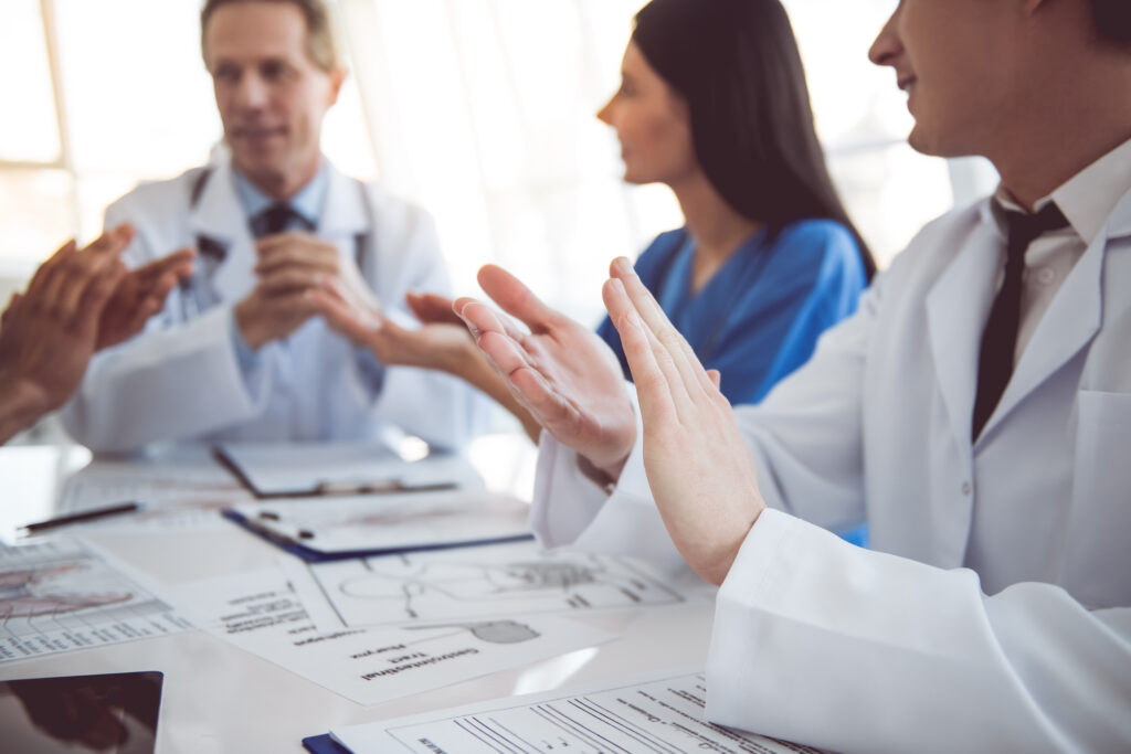 Veterinarians are applauding during a conference.