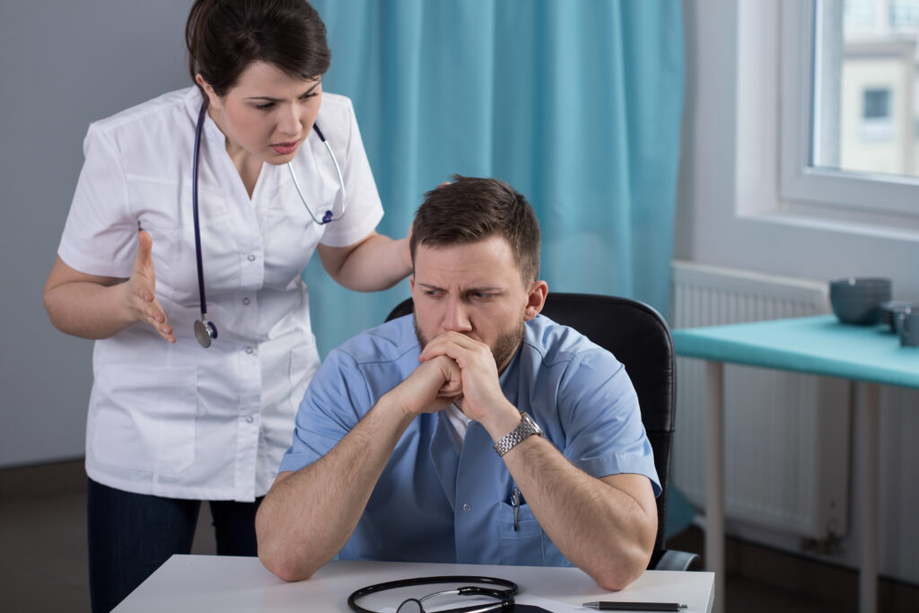 A female doctor is frustrated with a male doctor.