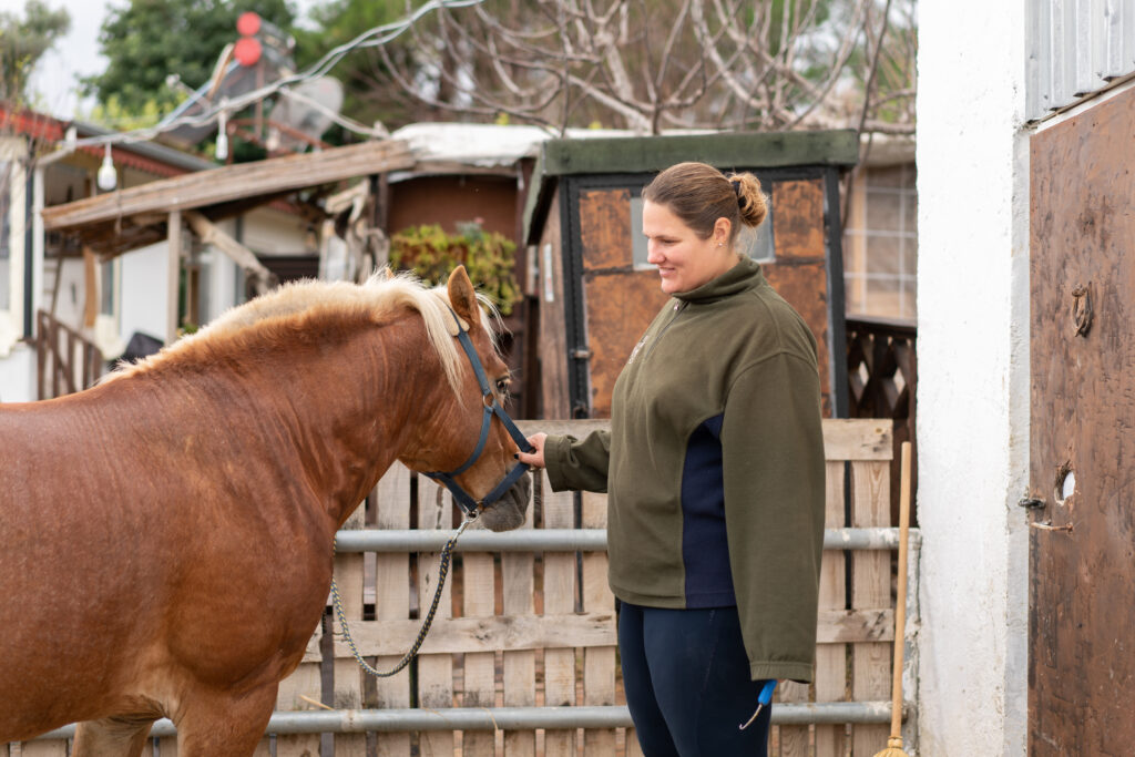 Overweight horse with smiling woman