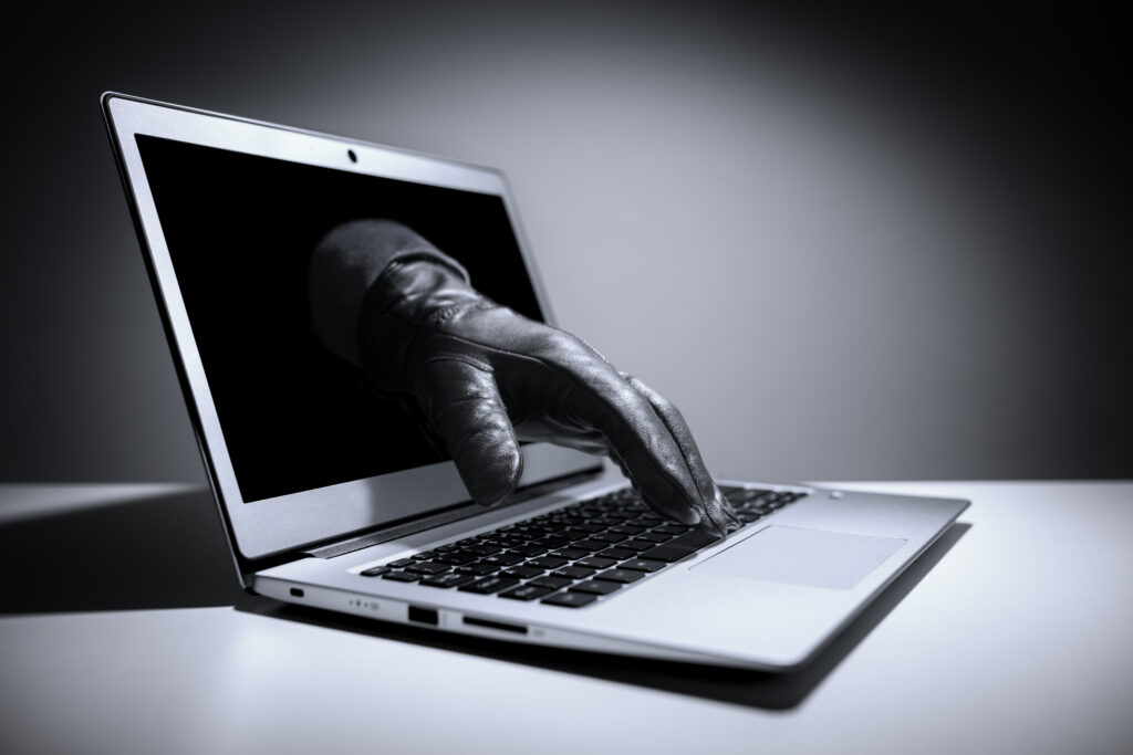 Gloved hand reaching through computer screen
