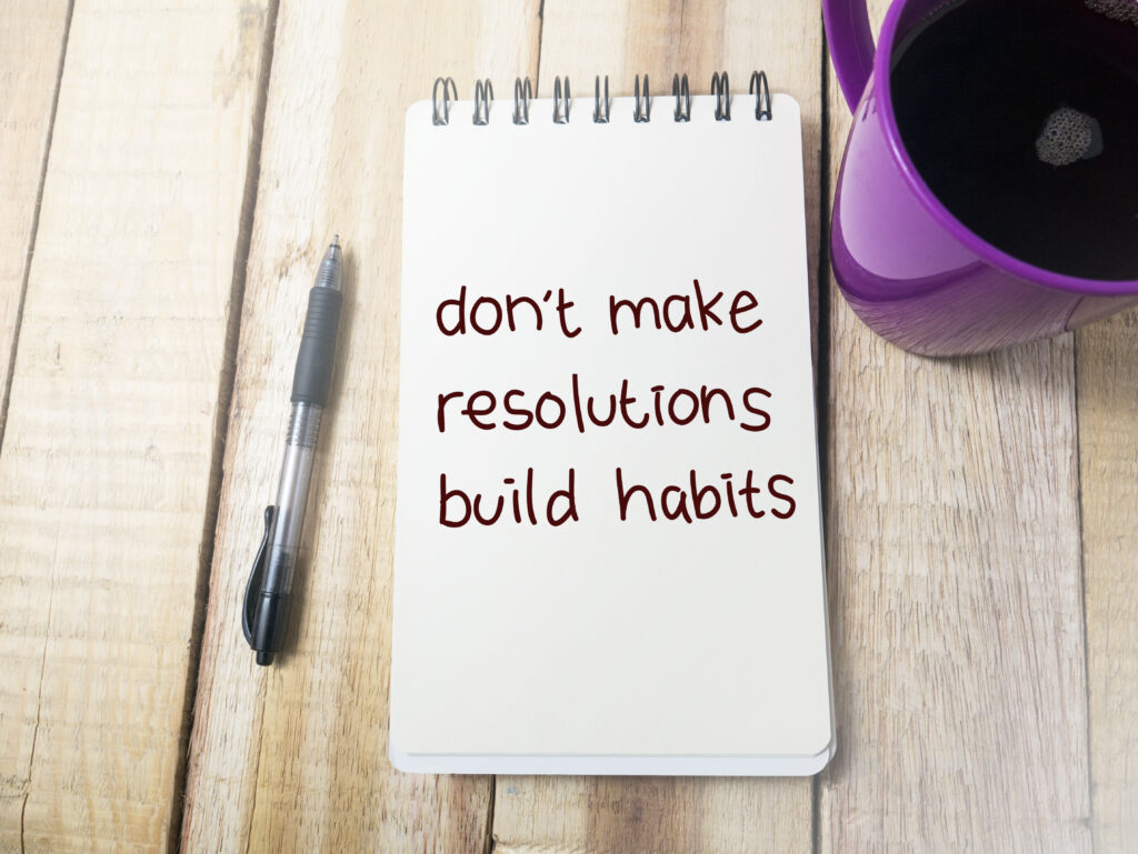 Don't Make Resolutions Build Habits, business motivational inspirational quotes, words typography top view lettering concept. Building habits helps you stay true to yourself in veterinary practice.