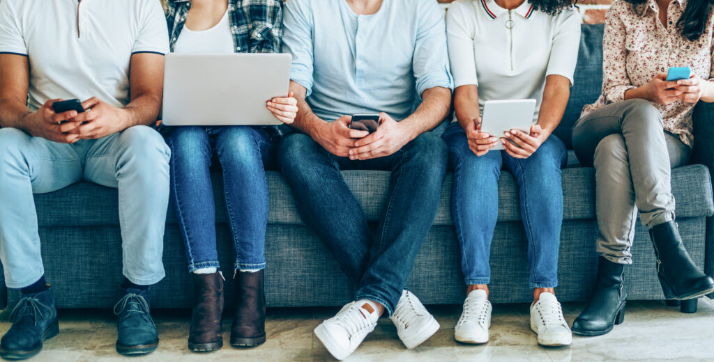 Group of young people with smart phones, digital tablets and laptop. These social media tips for veterinarians will help you determine the best content for each device.