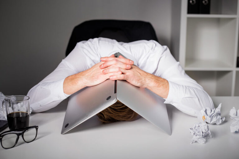 vet head under laptop unhappy
