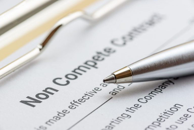 Blue ballpoint pen on a non compete contract. Noncompete contract is an agreement between employee and employer, not to enter into competition in subsequence business effort. Legal concept
