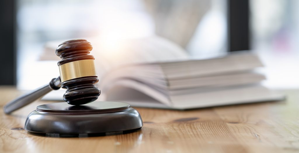 Judge gavel with stack of paper in the background