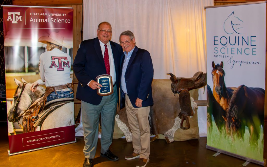 Dr. Kenneth Harrington McKeever (left) poses with Dr. Joe Pagan, CEO of Kentucky Equine Research, Inc. (right), after receiving a plaque commemorating his elevation to the status of Fellow of the Equine Science Society, honoring his years of service to the society, as well as to the broader equine community. (Photo by: Kyle Hartmann)