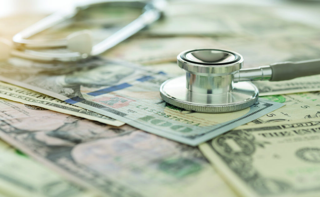 Stethoscope on money, representing veterinary discounting.