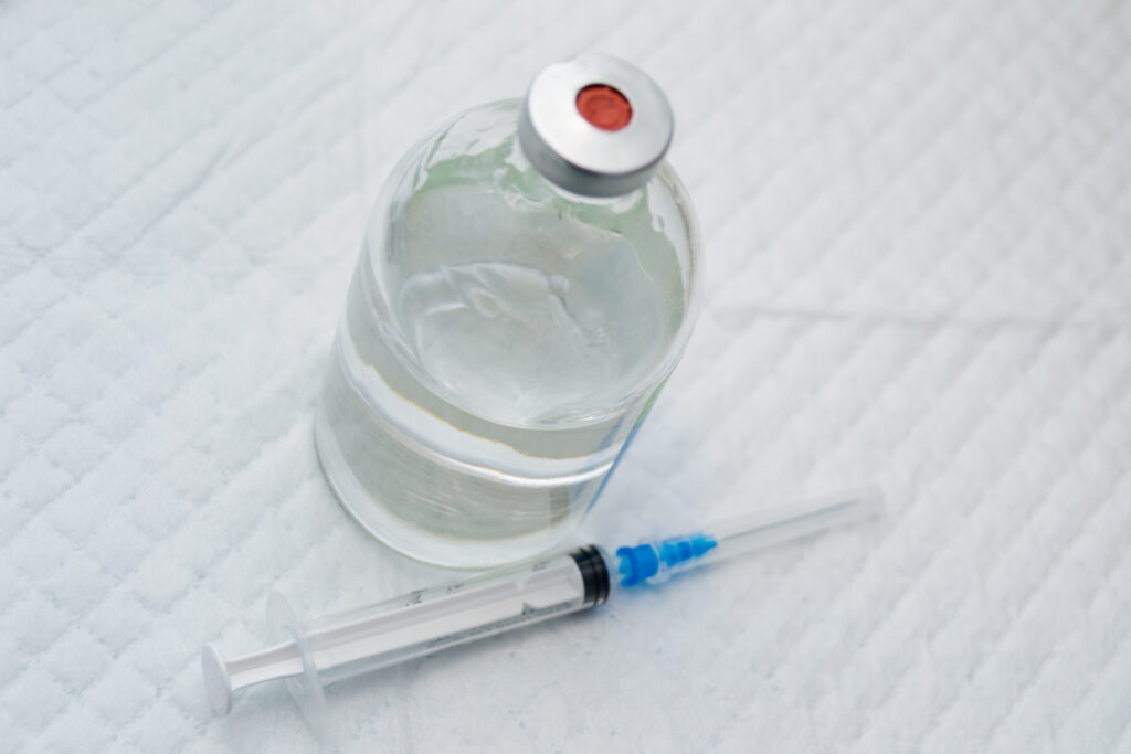 Drug vial and needle, representing xylazine. 