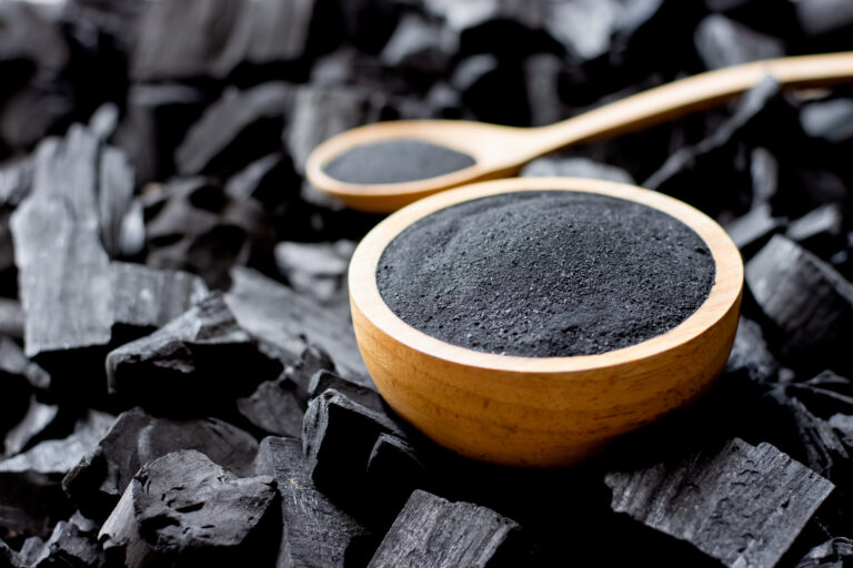 Charcoal is crushed and put into a large cup of charcoal