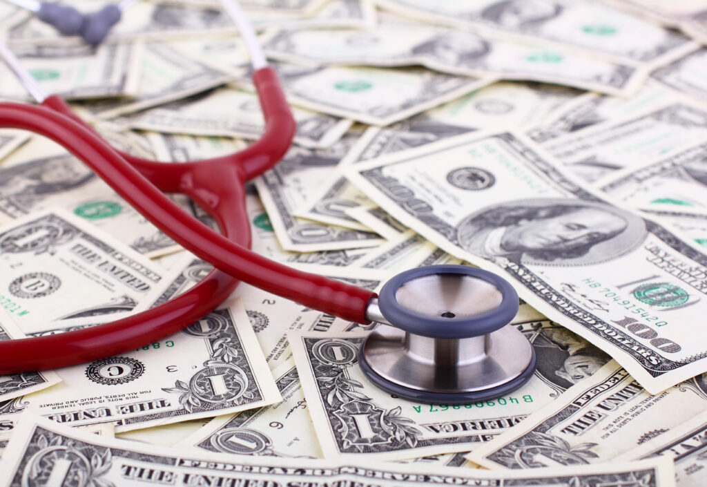 Stethoscope and cash, symbolizing starting a veterinary practice with cash