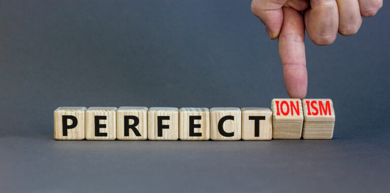 Perfectionism symbol. Concept words Perfect or Perfectionism beautiful wooden blocks. Beautiful grey table grey background. Businessman hand. Business and perfectionism or perfect concept. Copy space