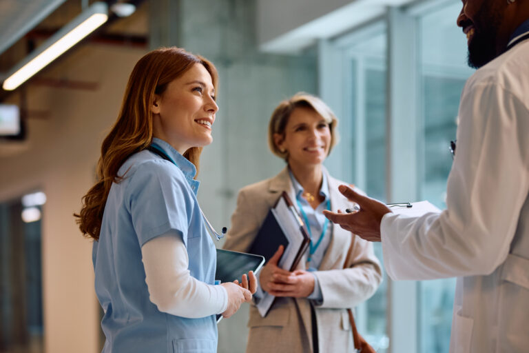 Happy nurse on a meeting with hospital administrator and doctor