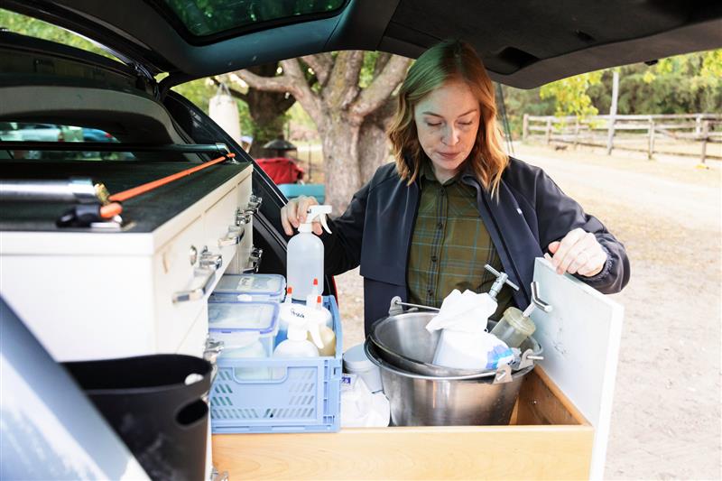 Ambulatory equine veterianrian disinfecting equipment as part of biosecurity program.
