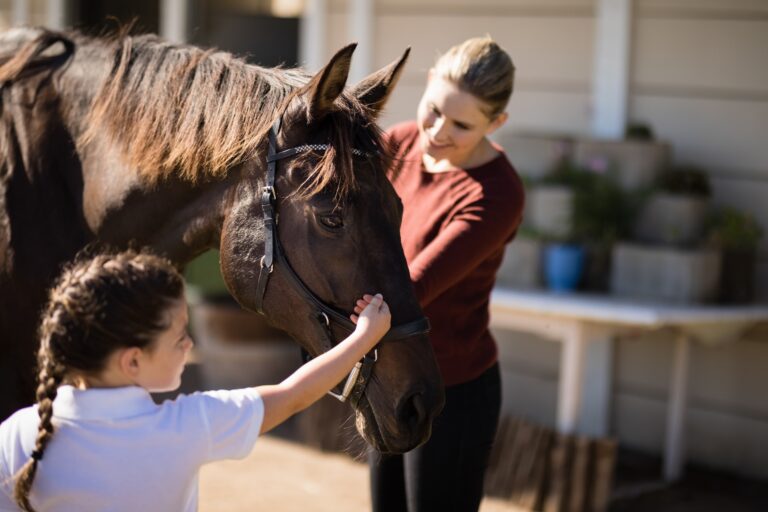 Mother and daughter touching the horse