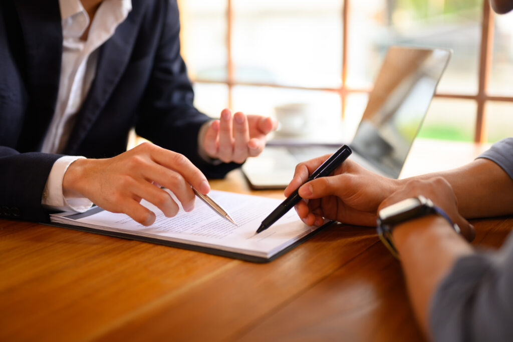 Attorney and client reviewing an equity exchange contract. 