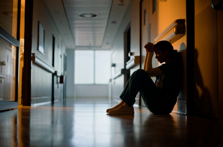 Doctor, stress and woman with depression, burnout and tired in hospital for medical news